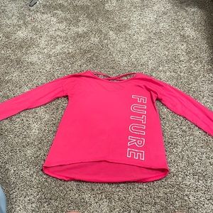 This is a pink kids shirt that says FUTURE on it and is a size medium
